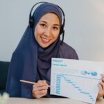 muslim-lady-using-laptop-talk-to-colleagues-in-vid-9YBZ8E8